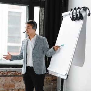 Engaging business presentation by a call center agent using a flip chart, indoors.